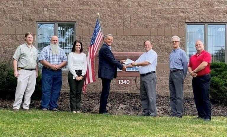 Team photo in front of the Valv-Trol office building